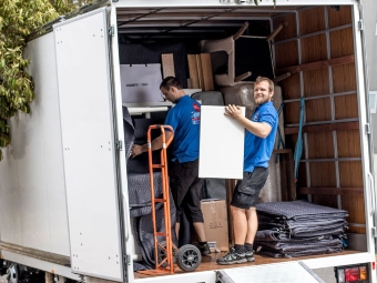 man holding furniture inside removalist truck heading to an suburb in western sydney